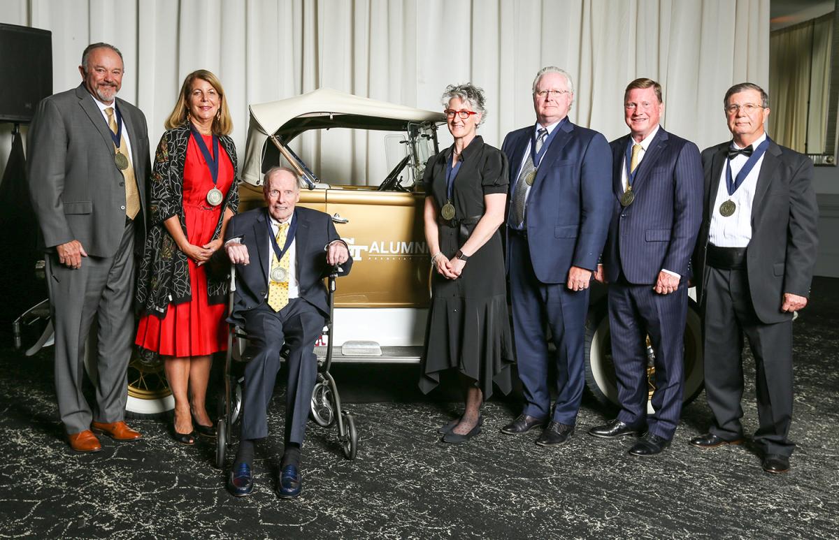 The College of Engineering Hall of Fame inductees gathered around the Ramblin' Wreck
