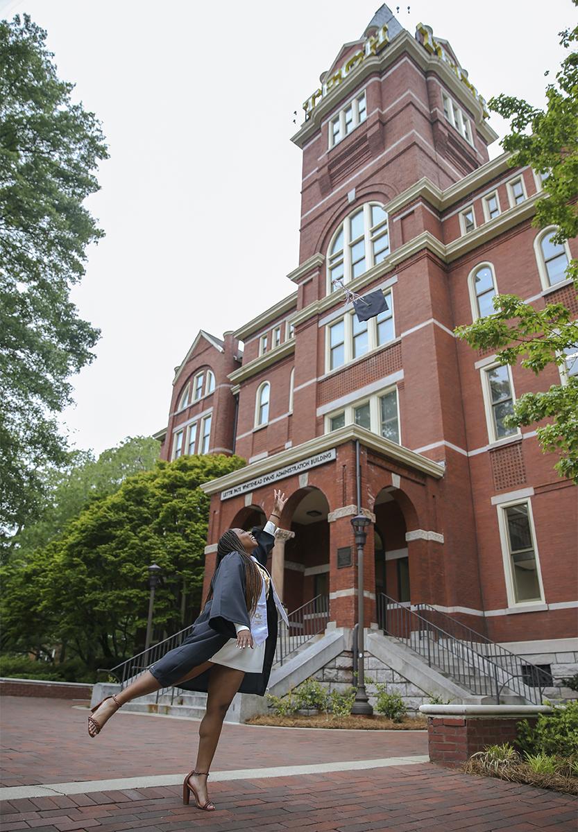 Fatima Sheriff tosses her mortarboard in front of the Tech Tower