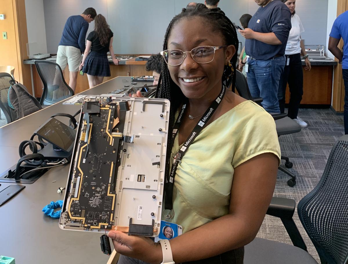 Fatima Sheriff holds a device motherboard at her Microsoft internship