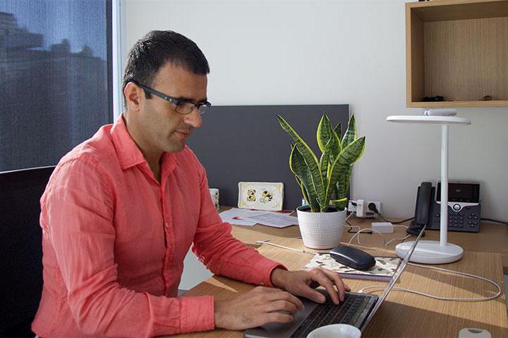 Cybersecurity expert Saman Zonouz works at a laptop