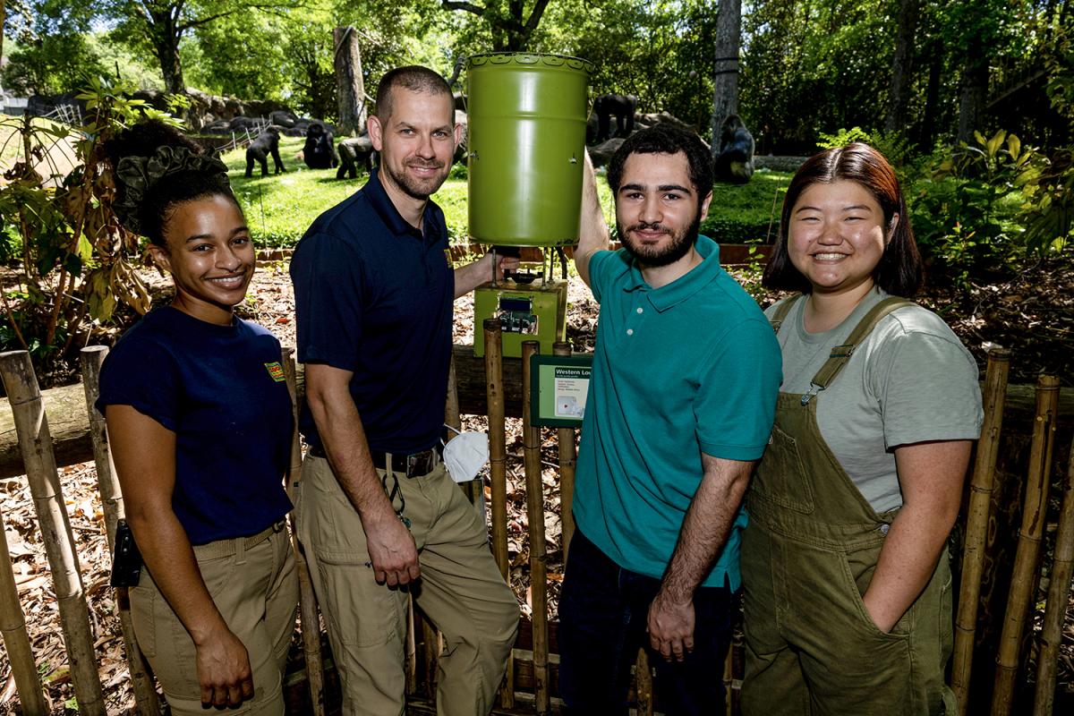 Zoo Atlanta keepers and Georgia Tech students with the new feeder at the gorilla habitat.
