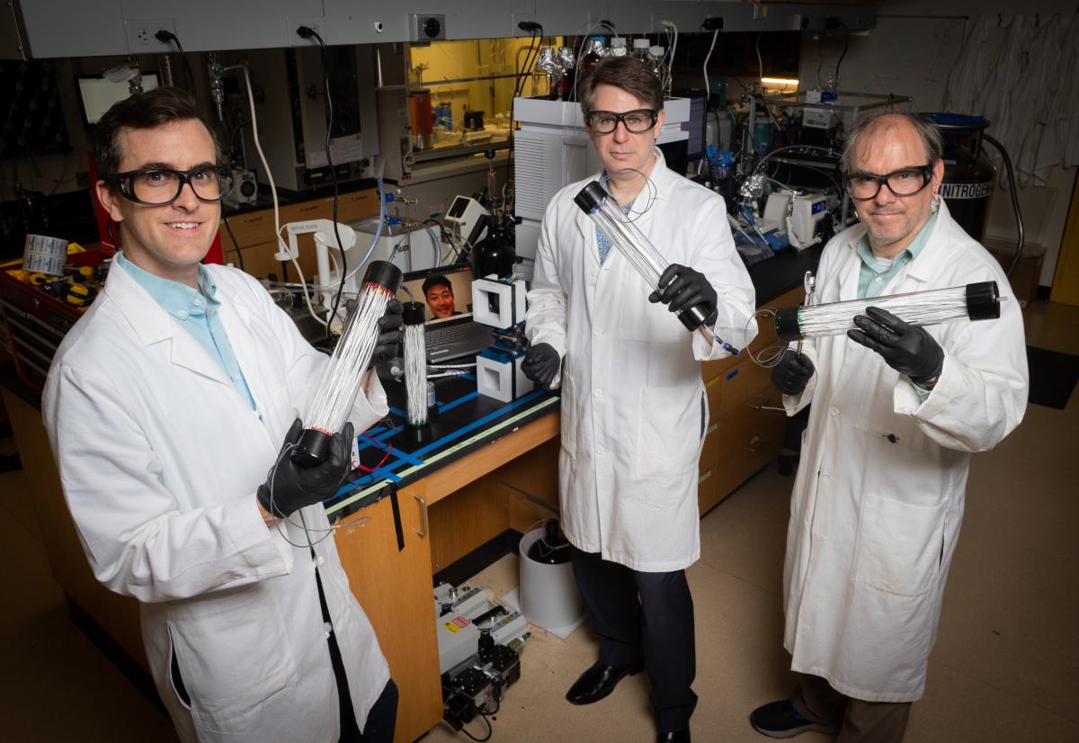 Ryan Lively, Chris Jones, and Matthew Realff display the tubes of carbon fibers in the lab