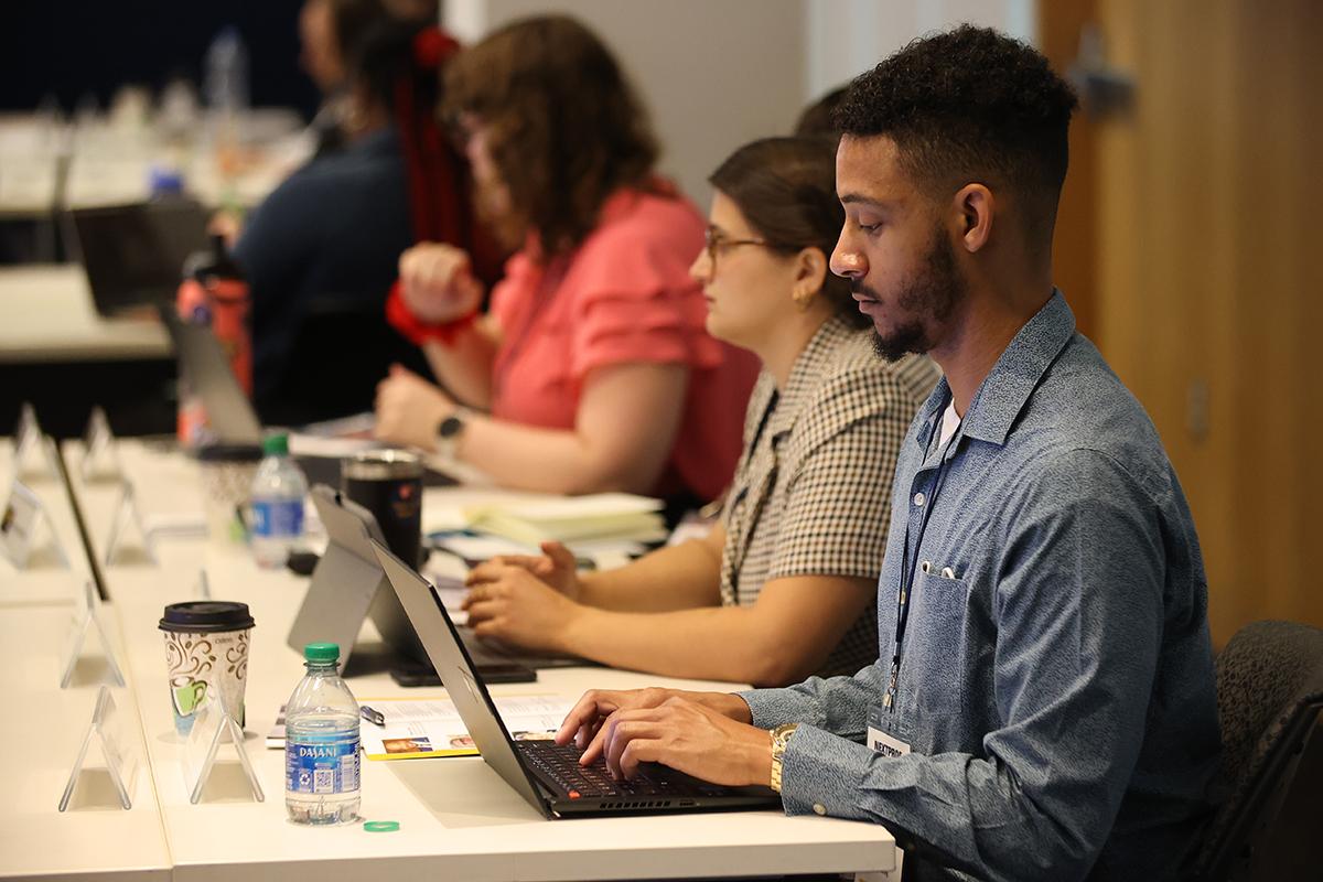 Marquise Bell takes notes on his laptop during a session at NextProf Nexus 2023. (Photo: Candler Hobbs)