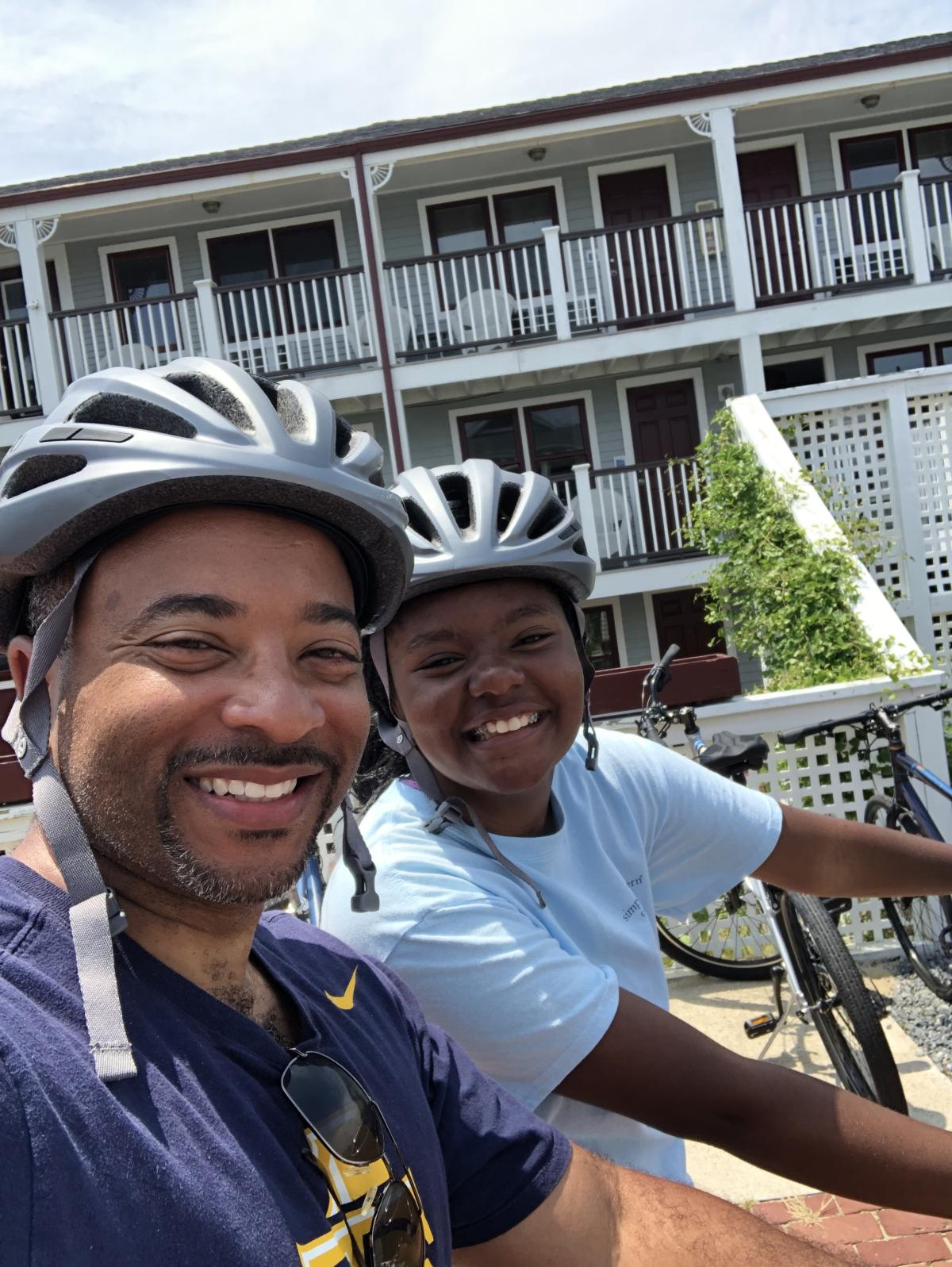 Raheem Beyah and his daughter Brie biking