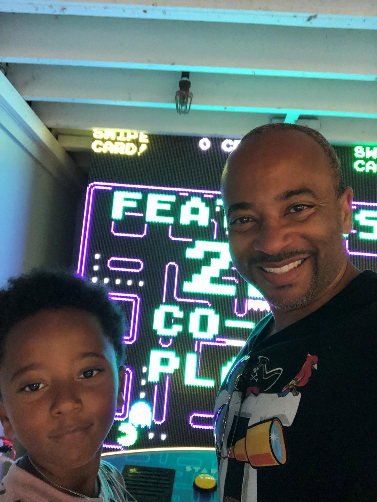 Raheem Beyah and his son play arcade video games