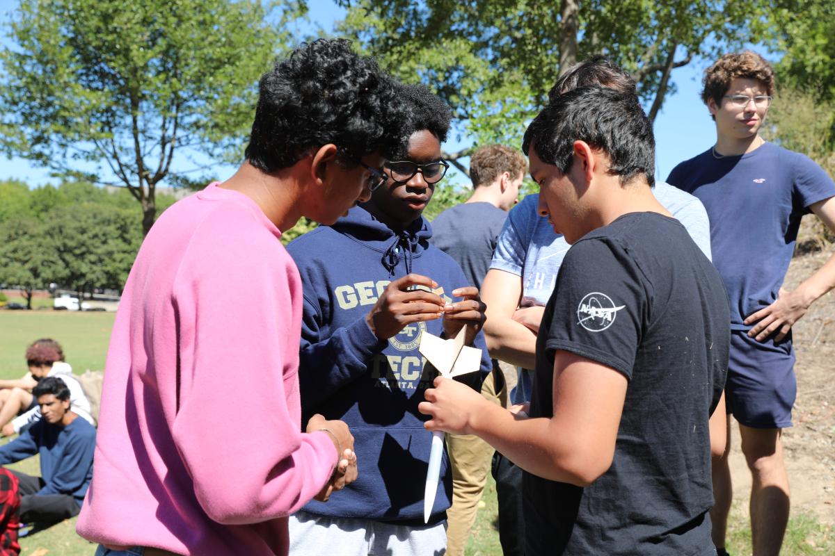 Aerospace engineering students test model rockets outside