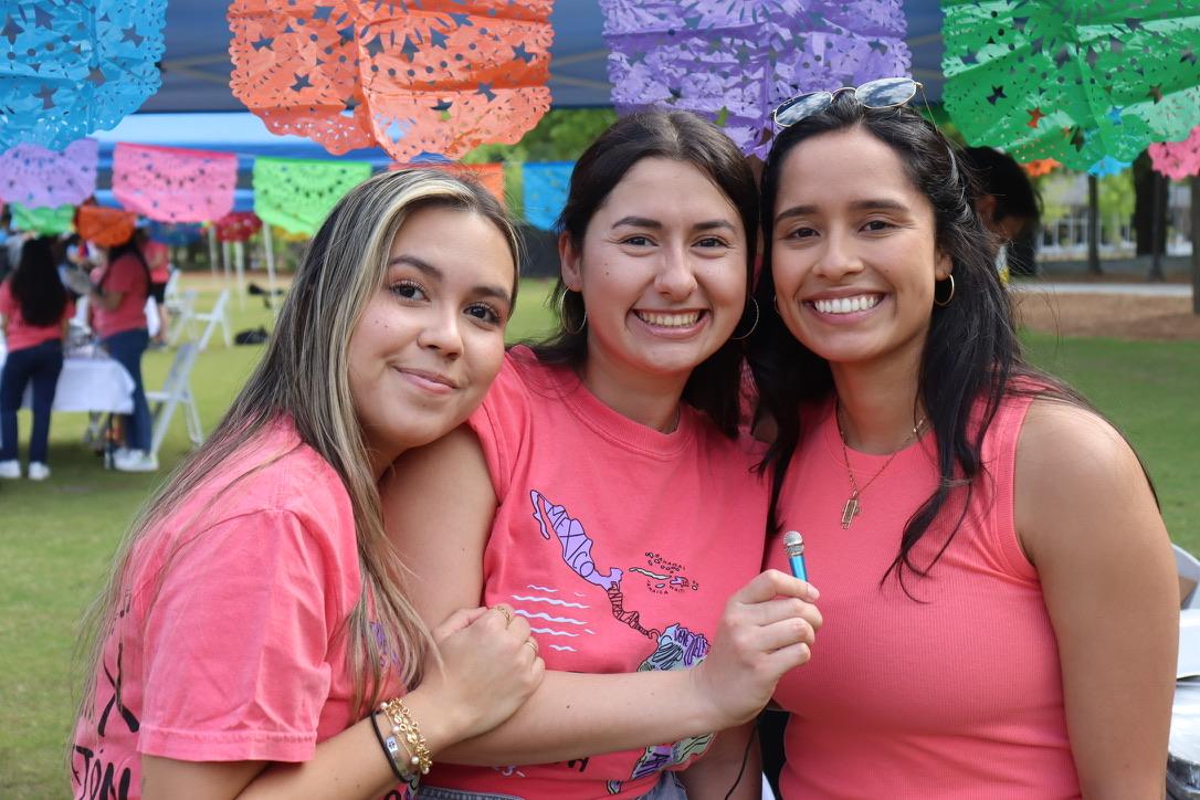 three female hispanic students looking at camera