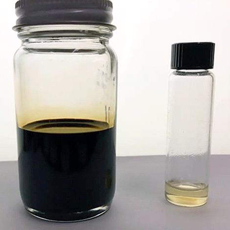 Two clear containers. A larger jar with dark, raw crude oil, and a smaller jar with a smaller volume of nearly clear liquid.