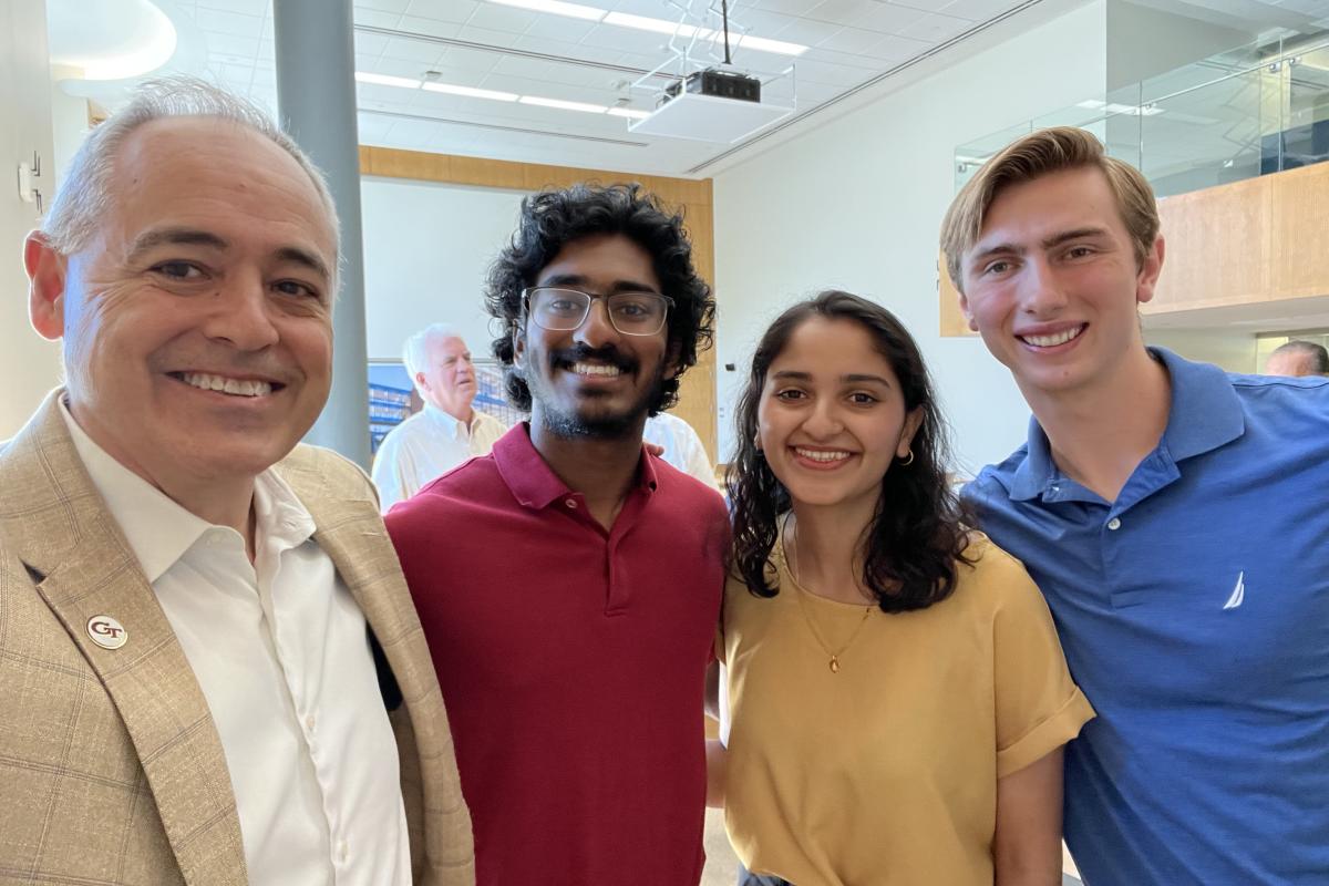 Georgia Tech President Ángel Cabrera with FADpad team members Girish Hari, Netra Gandhi, and Ethan Damiani.