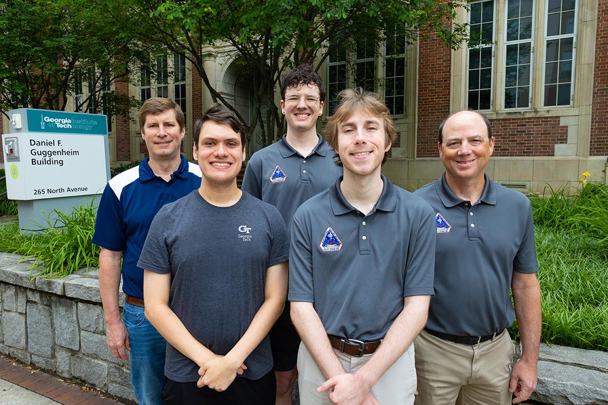 A group of five people, looking at the camera.