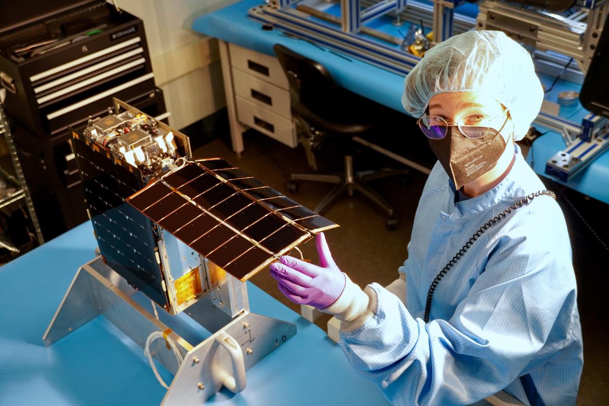 Celeste Smith standing in lab with Lunar Flashlight