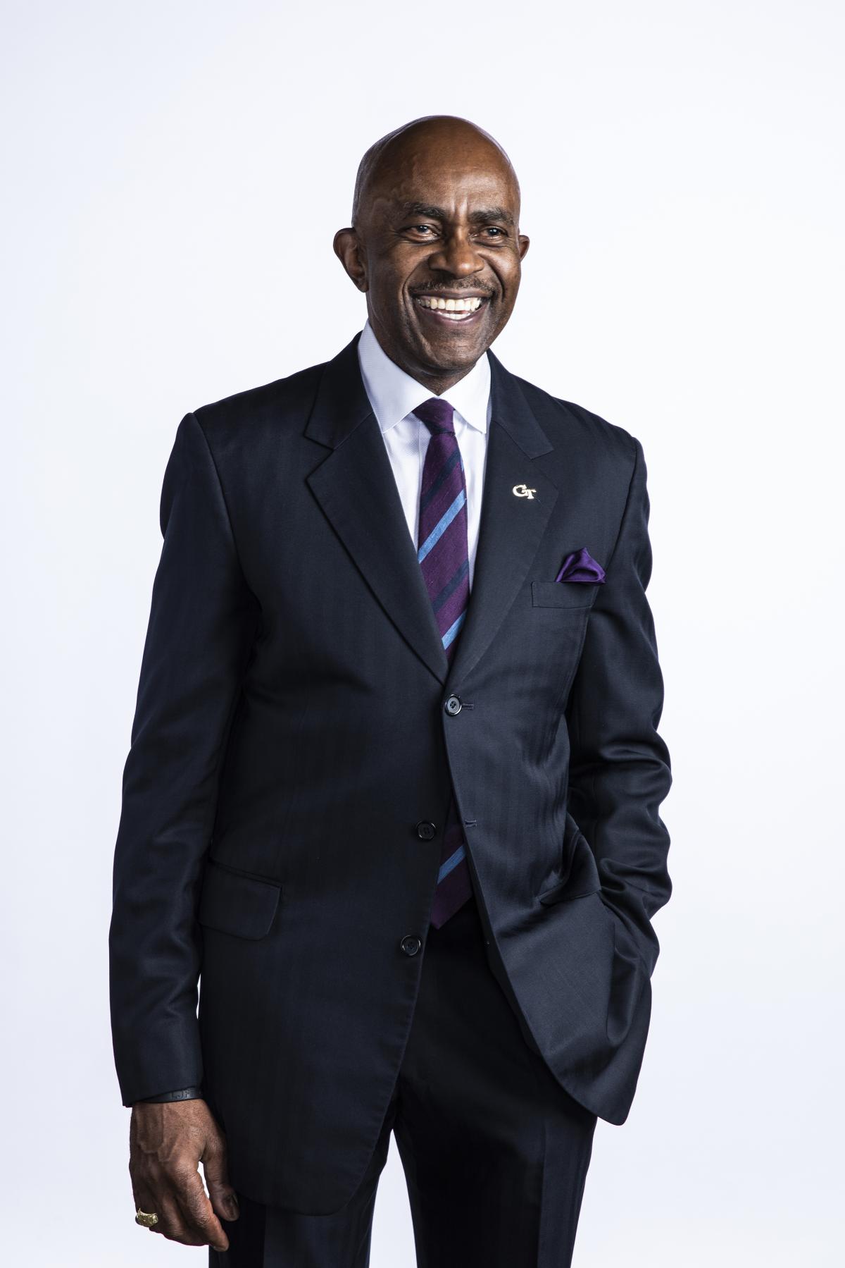 Ronald Johnson stands against a white background in suit and tie.