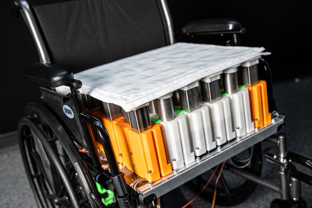 Closeup view of a customized wheelchair system, including fabric sensors, design to prevent pressure injuries