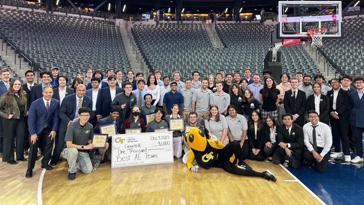 group of people looking at camera with oversized check