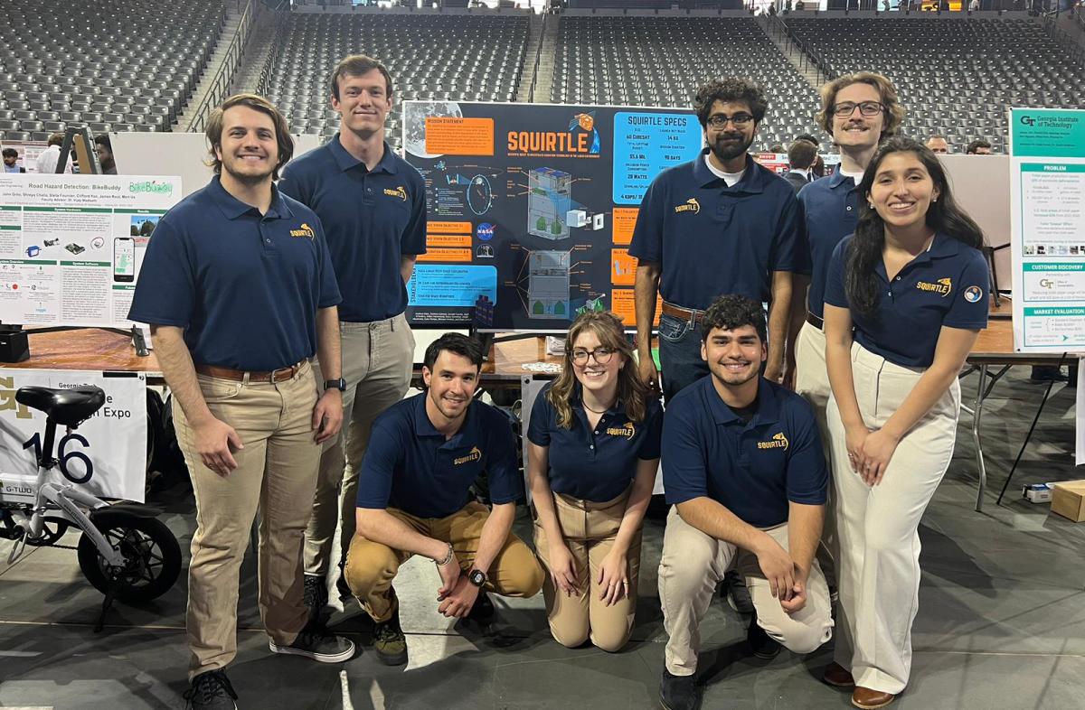 A group of AE students with their project poster at the Capstone Design Expo