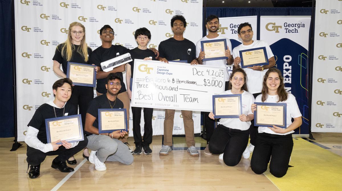 group of students with oversized checks and certificates
