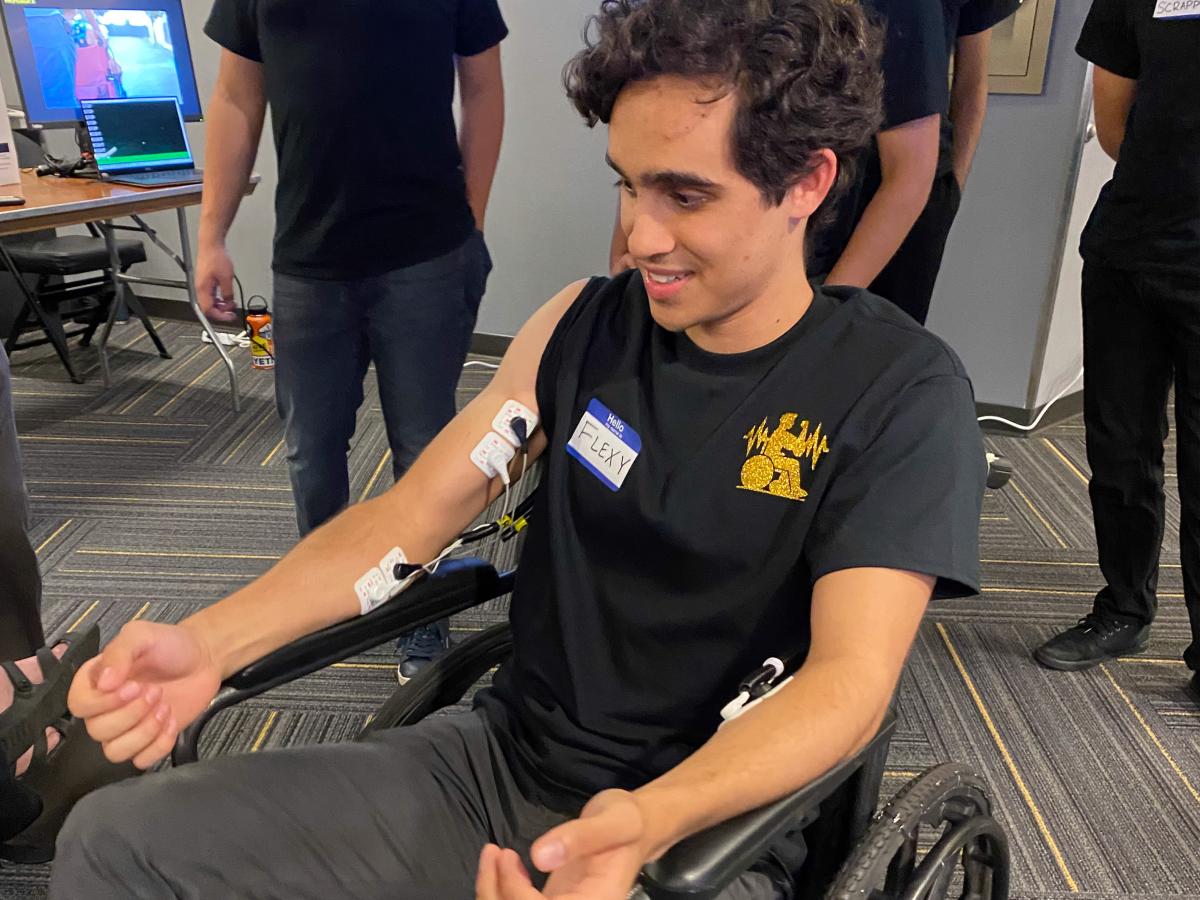 student in wheelchair with sensors on arms