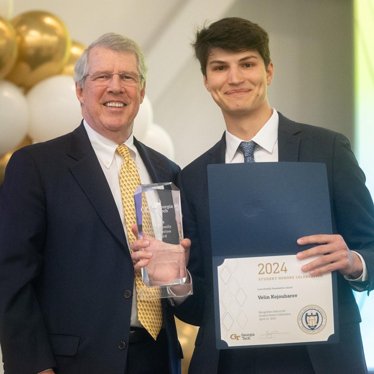 Jimmy Love presents the Love Family Foundation Award to Venny Kojouharov, who holds a clear acrylic award and a certificate. (Photo: Allison Carter)