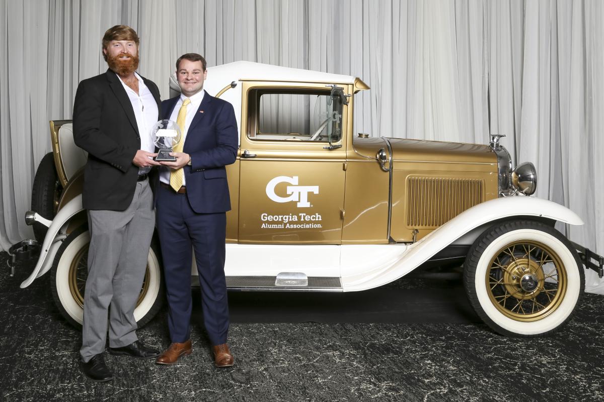 Frederick Grimm and John Gattuso hold trophy at Ramblin Wreck