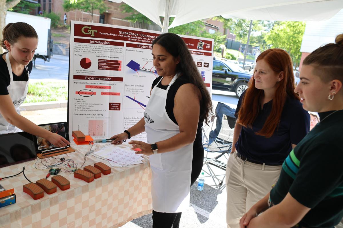 students show device to test steak cooking