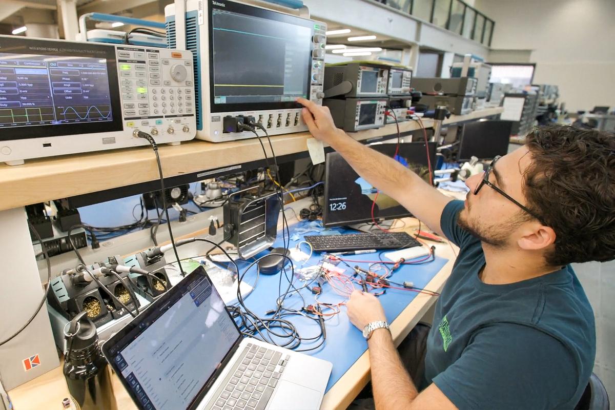 A student uses a laptop and other technology