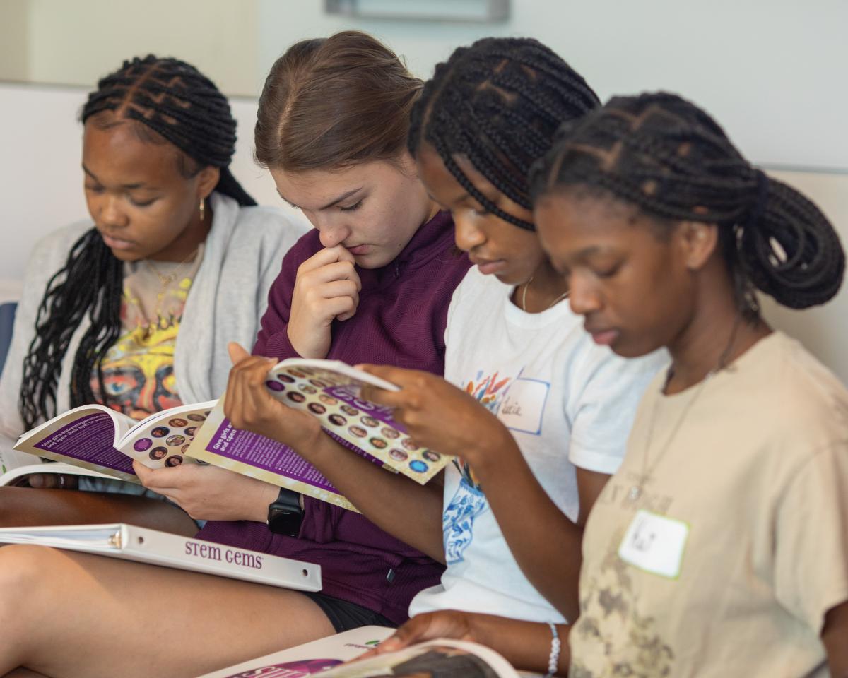 students looking at books