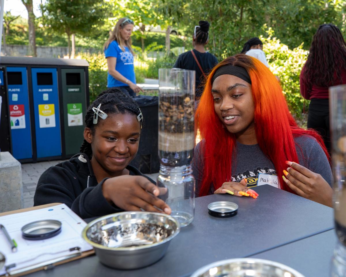 Facilitator and student looking at water filtration system