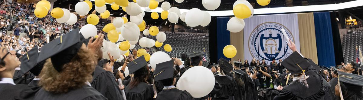 students at ceremony with balloons