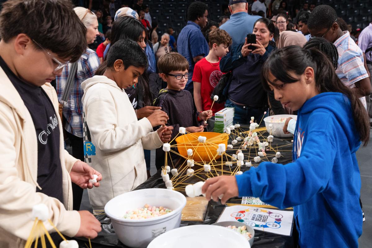 kids attach marshmallows and pasta to learn about stem