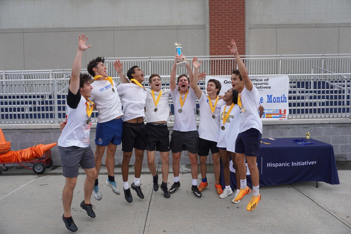 students celebrating with trophy