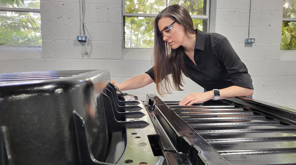 Amanda Nummy looks at a model truck bed in the lab