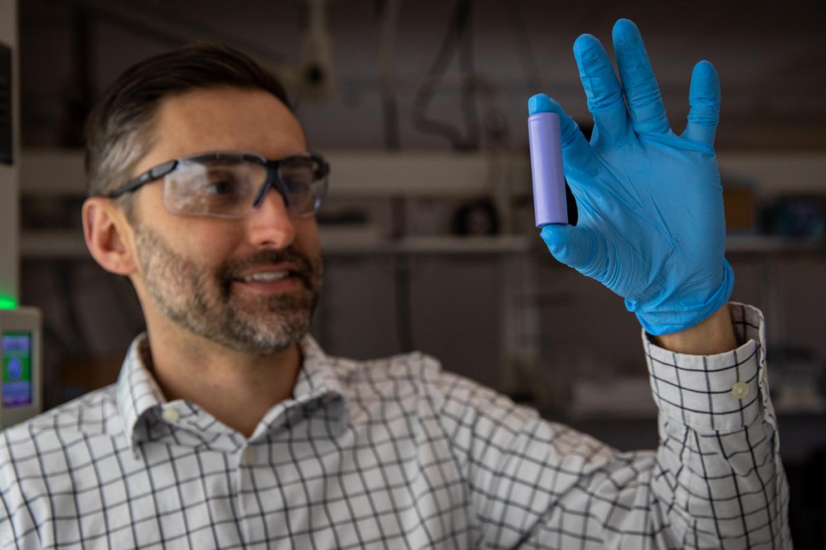 Matt McDowell holds up a lithium-ion battery