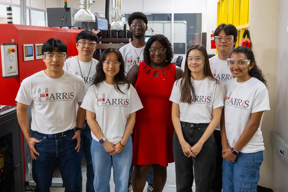 a group of people standing in the lab