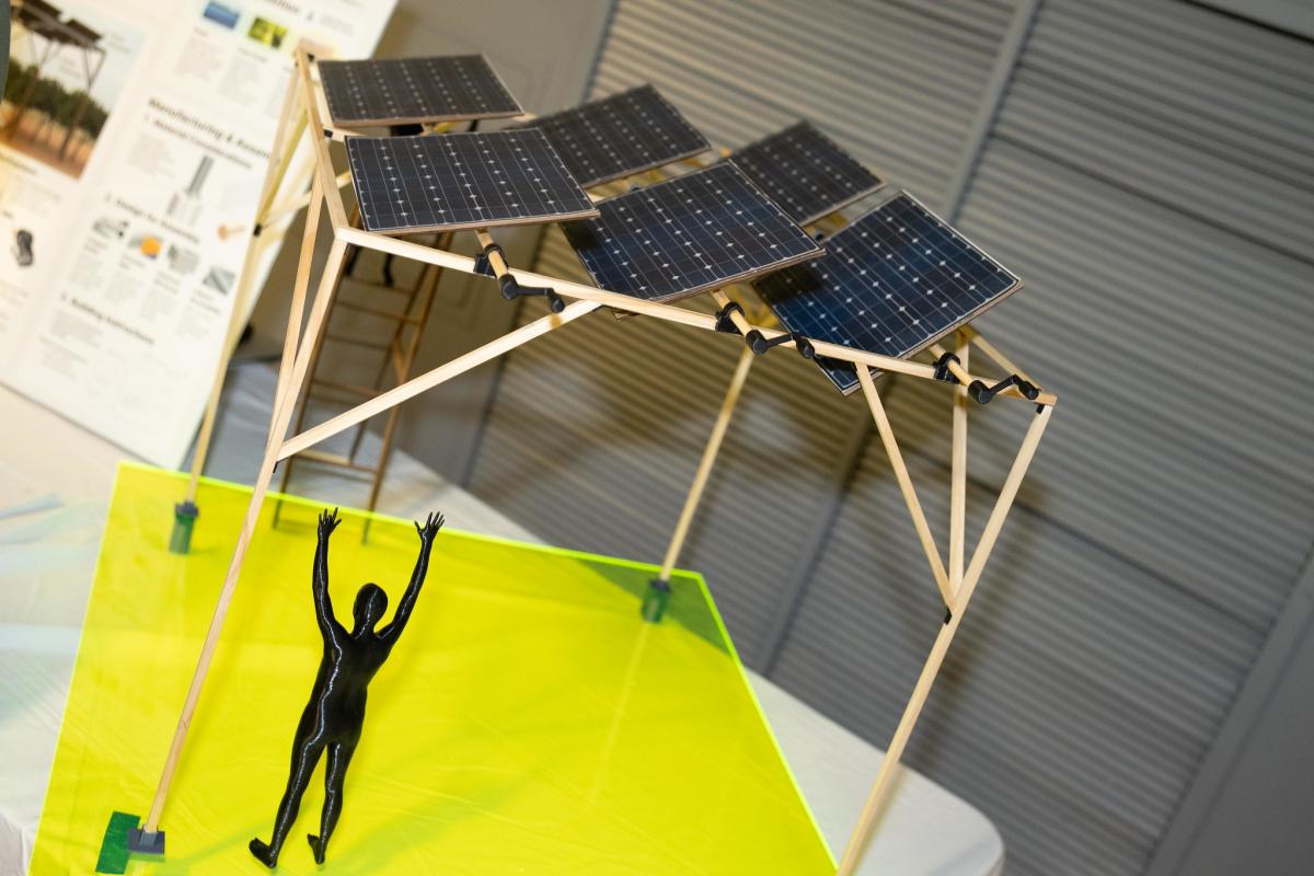 a model of small solar panels with small human silhouette