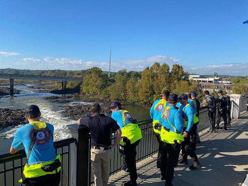 firemen testing gather around columbus river to test first alert system
