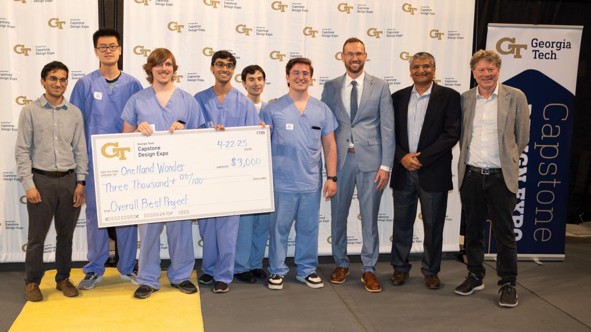 group of people standing with oversized check