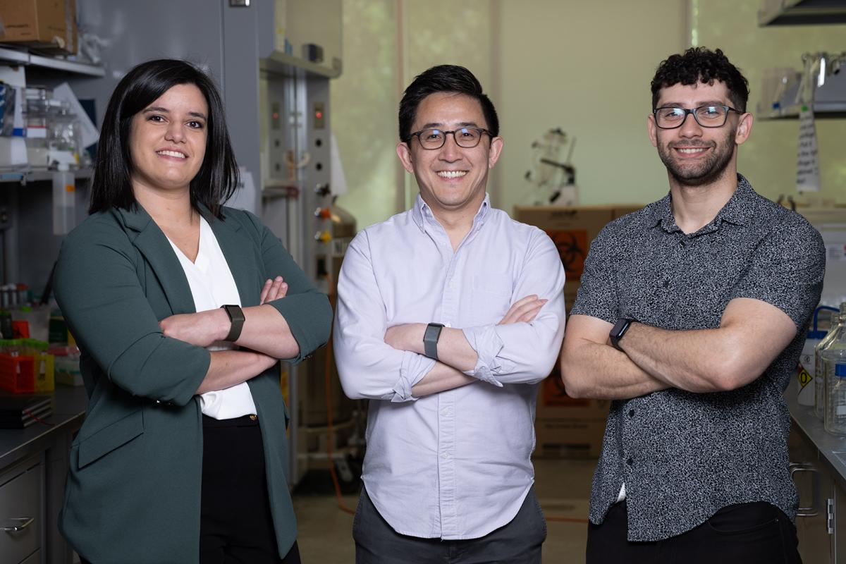 Lena Gamboa, Gabe Kwong, and Ali Zamat pose in their lab.