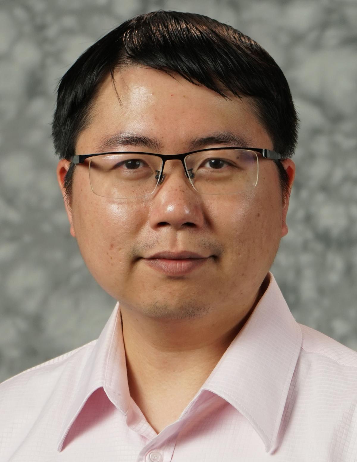 Shimeng Yu looking at camera wearing pink shirt
