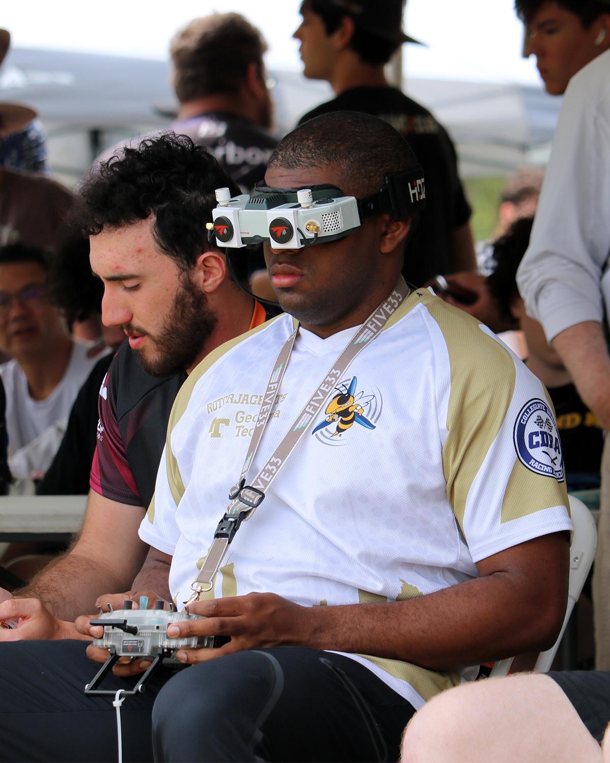 a student pilots a drone in a competition