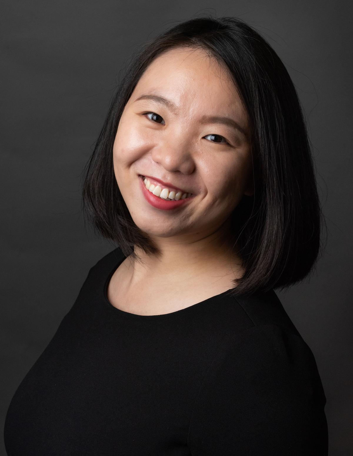 Fan Zhang smiling at camera wearing black