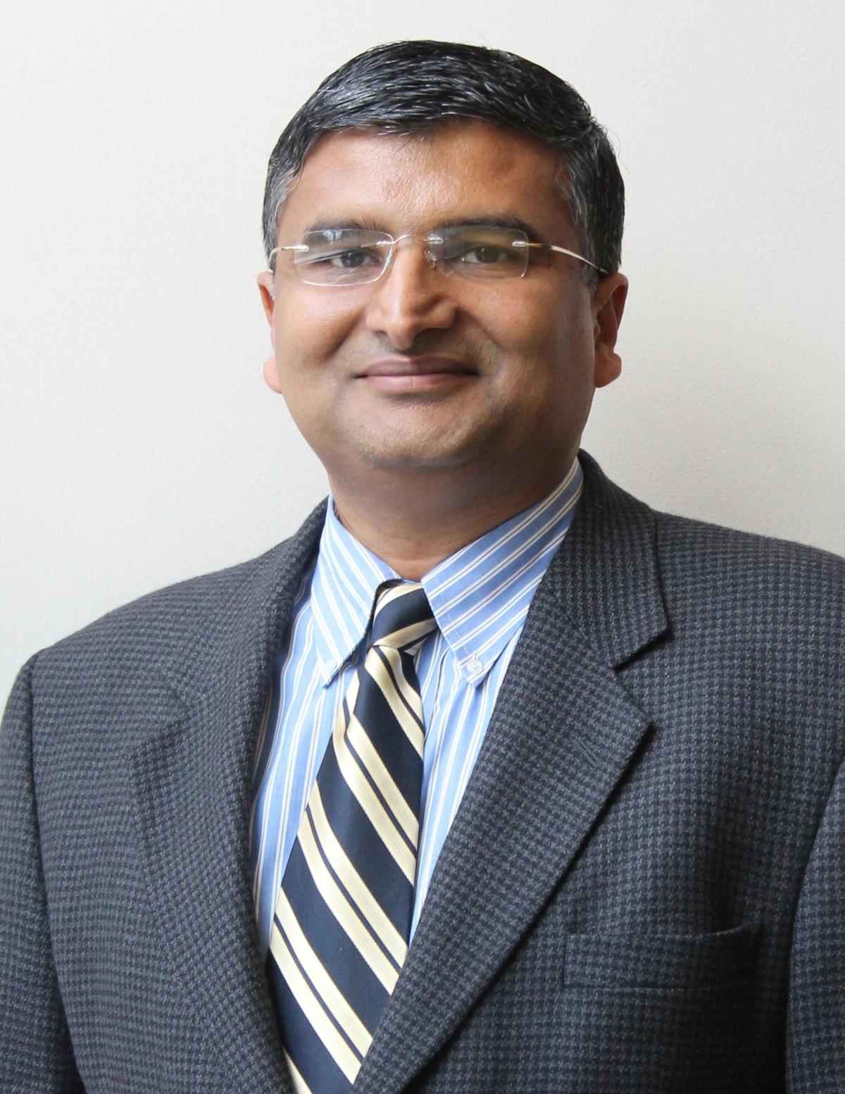 Jaydev looking at camera while wearing a suit