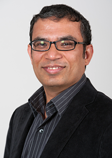 Rampi Ramprasad smiling at camera wearing black