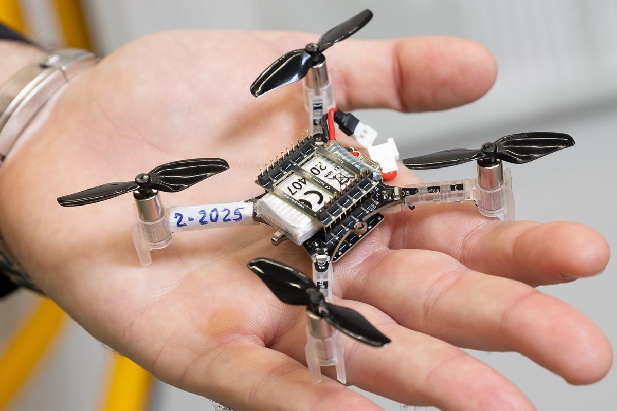 a closeup image of a hand holding a small drone