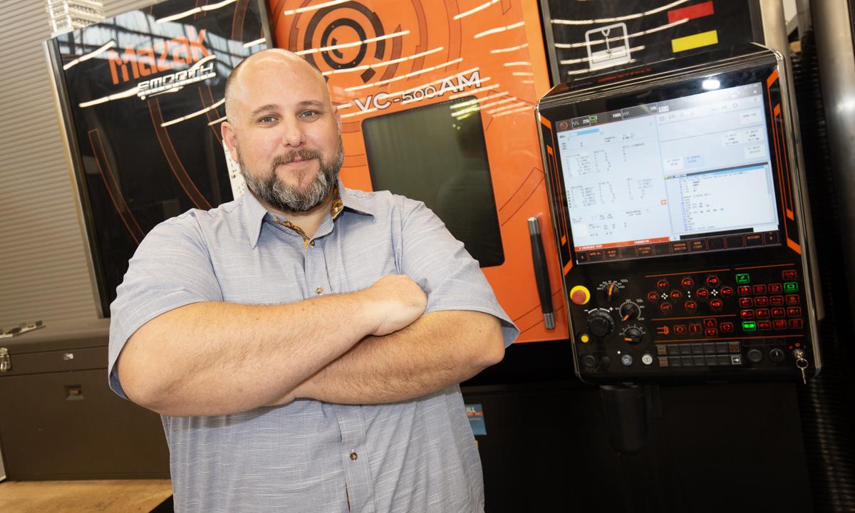 Aaron Stebner with a machine in the Advanced Manufacturing Pilot Facility