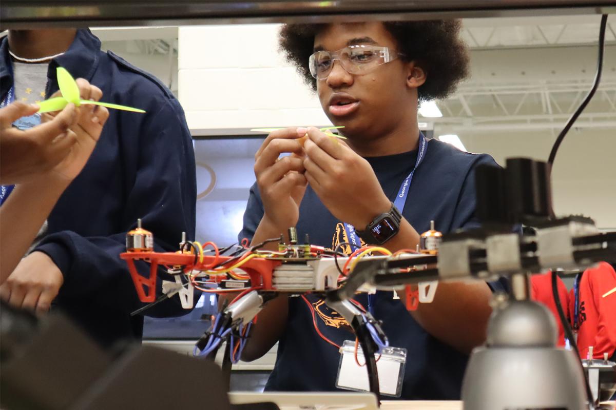 campers work on drone propellers in the lab