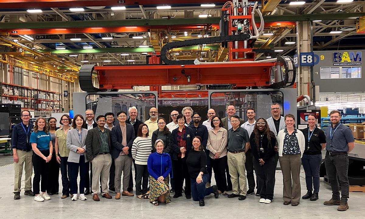 A group of visiting university researchers at Boeing's additive manufacturing facility.