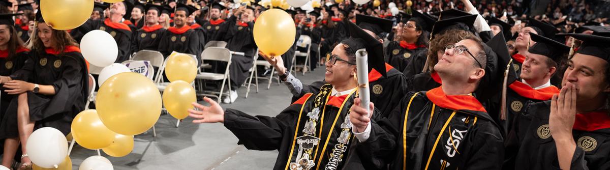 balloons falling on grads at ceremony