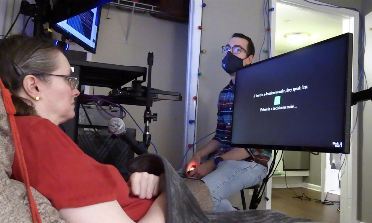 a woman looks at a tv screen with text on it