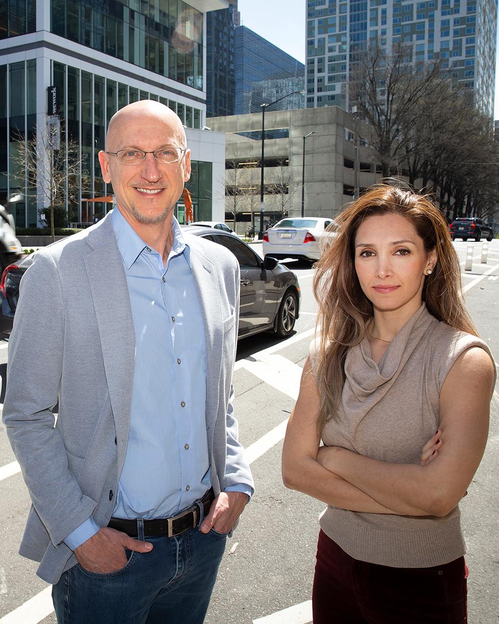 two people standing on the side of the street in Midtown Atlanta