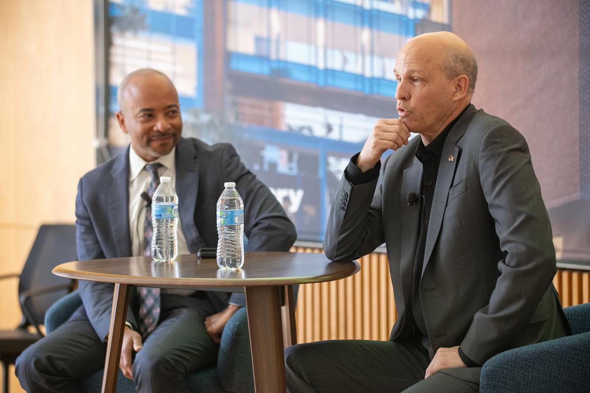 Raheem Beyah and Russell Ford chat at a table